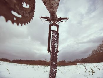Low angle view of snow on land against sky