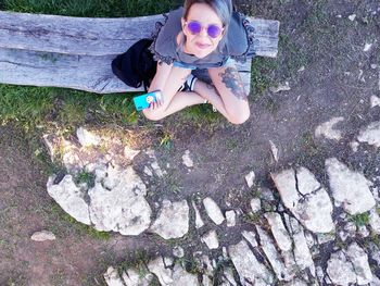 High angle view of girl sitting on plant