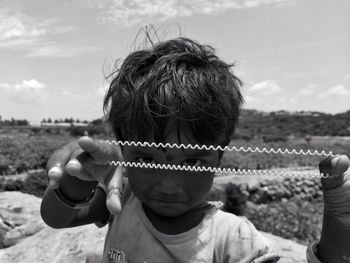 Portrait of cute girl holding phone cord