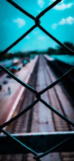 Close-up of chainlink fence against sky