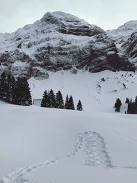 Scenic view of snow covered mountains against sky