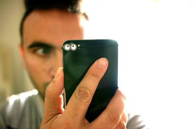 Close-up of man holding smart phone
