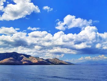 Scenic view of sea and mountains against sky