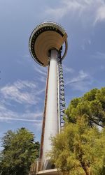 Low angle view of water tower against cloudy sky