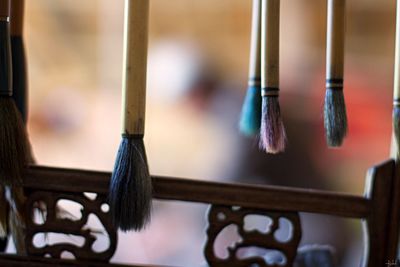 Close-up of paintbrushes hanging on table