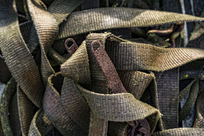 Full frame image of brown straps over rusty metal