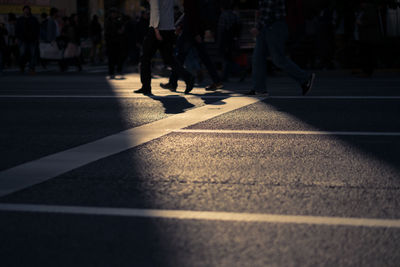 Low section of men crossing road