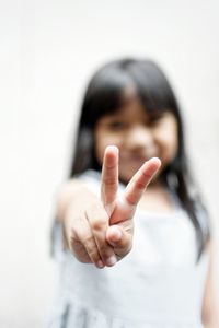 Girl gesturing peace sign
