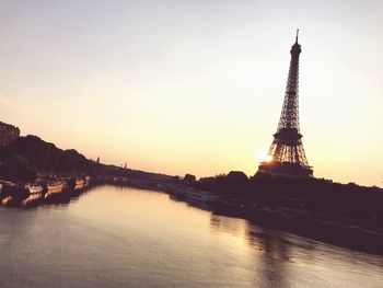 View of tower in city against sky during sunset