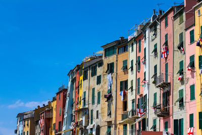 Low angle view of residential buildings against blue sky