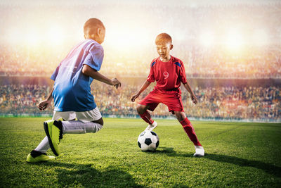 People playing soccer on field