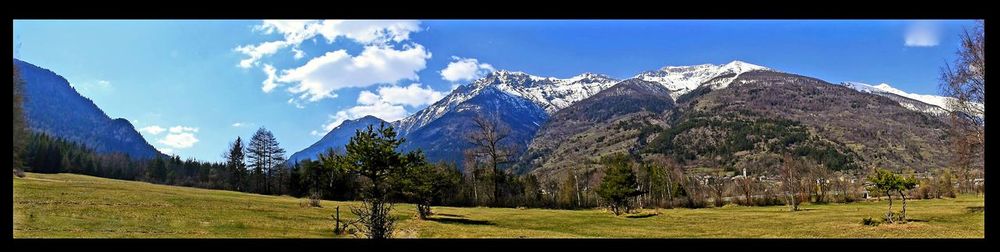 Panoramic view of trees and mountains against sky