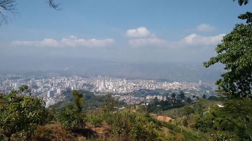 Panoramic view of sea and cityscape against sky