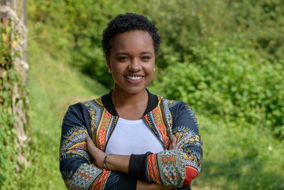 A young pretty african american businesswoman in a park with summer temperatures.