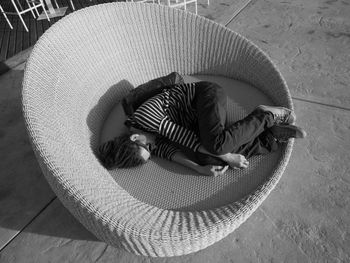 High angle view of woman sleeping on large chair
