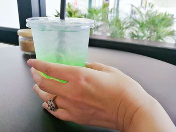 Close-up of hand holding drink