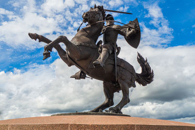 Low angle view of statue against sky