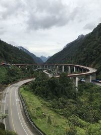 Road by bridge against sky