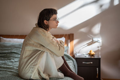 Young woman standing at home