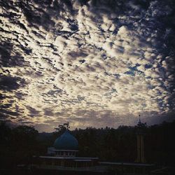 Low angle view of building against cloudy sky