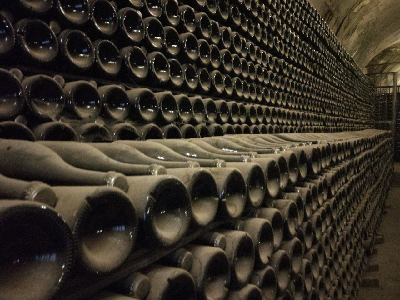 FULL FRAME SHOT OF WINE BOTTLES IN CONTAINER