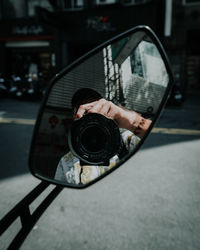 Man photographing car on street