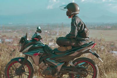 Man riding motorcycle on field