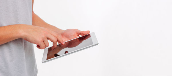Close-up of hand holding smart phone over white background