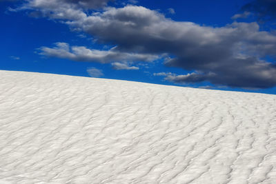 White sand dunes against sky