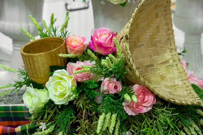 Close-up of rose bouquet in basket on table