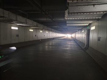 Empty corridor in illuminated building