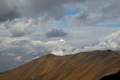 View of volcanic landscape against cloudy sky
