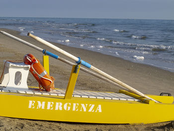 Text on beach by sea against sky