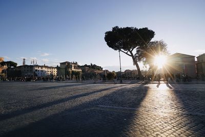 City street against clear sky during sunset