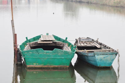 Boats moored in lake