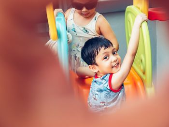 Cute siblings playing with toys at home