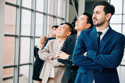 Businessmen shaking hands in office