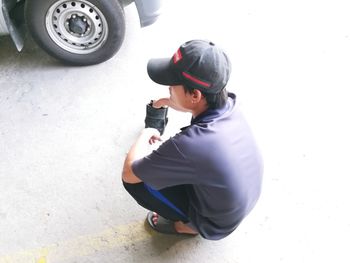 High angle view of boy sitting in car