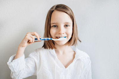 Girl brushes her teeth, dental care since childhood, a visit to the dentist