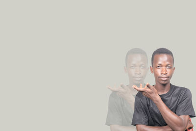 Portrait of young man against white background