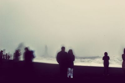 Rear view of silhouette people on beach