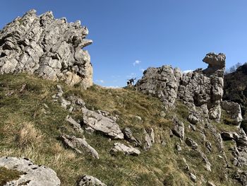 Low angle view of rocks against clear sky