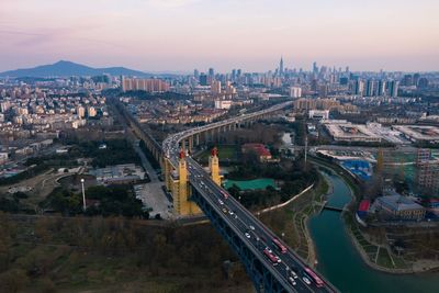 High angle view of road by buildings against sky