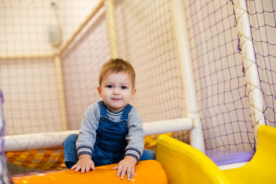 Portrait of cute girl playing on slide