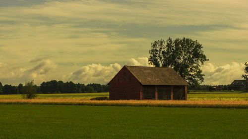 House on field against sky