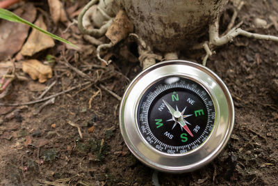 High angle view of navigational compass on footpath