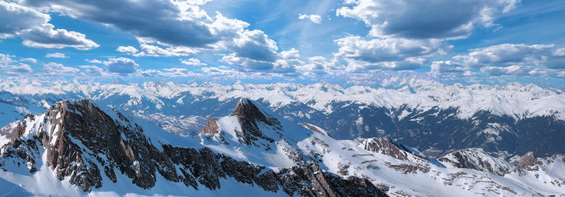 Sunny austrian alps under dramatic cloudy sky in winter