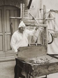 Man working on barbecue grill