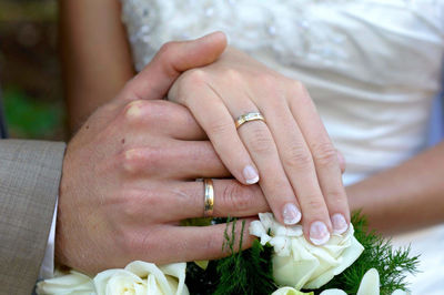 Midsection of couple holding hands