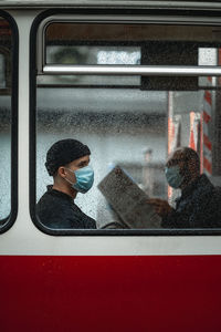 People looking through train window